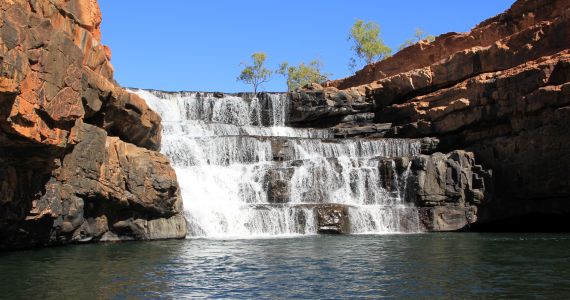 Travellers swimming at Bell Gorge waterfall as part of our Kimberley Tours